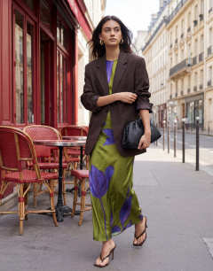 Model wearing Satin sleeveless asymmetric drape maxi dress in green and blue floral