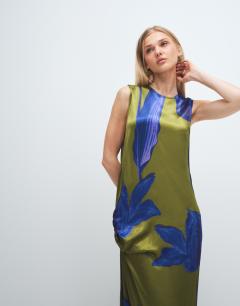 Model wearing Satin sleeveless asymmetric drape maxi dress in green and blue floral
