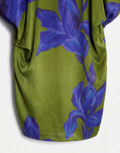 Model wearing Satin sleeveless asymmetric drape maxi dress in green and blue floral