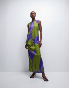 Model wearing Satin sleeveless asymmetric drape maxi dress in green and blue floral