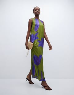 Model wearing Satin sleeveless asymmetric drape maxi dress in green and blue floral
