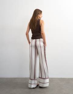 Model wearing Satin stripe tie waist wide leg trouser co-ord in ivory and chocolate