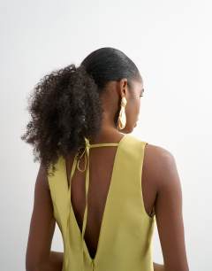 Model wearing Satin structured dropped waist maxi dress in washed lime