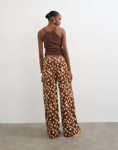 Model wearing Satin tie waist wide leg trouser in abstract animal