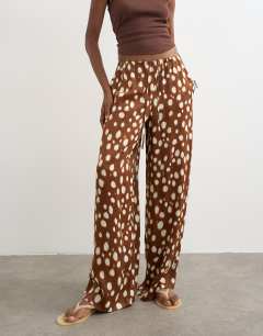 Model wearing Satin tie waist wide leg trouser in abstract animal