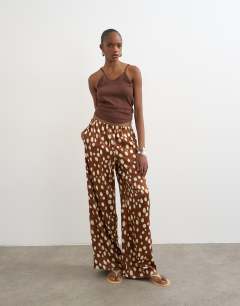 Model wearing Satin tie waist wide leg trouser in abstract animal