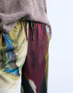 Model wearing Satin tie waist wide leg trouser in abstract print