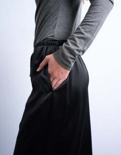 Model wearing Satin tie waist wide leg trouser in black