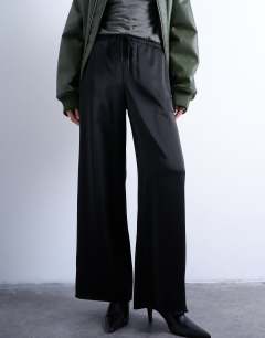 Model wearing Satin tie waist wide leg trouser in black