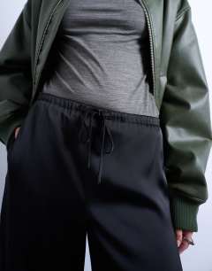 Model wearing Satin tie waist wide leg trouser in black