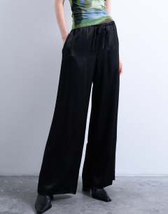 Model wearing Satin tie waist wide leg trouser in black