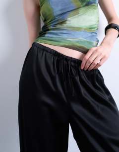 Model wearing Satin tie waist wide leg trouser in black