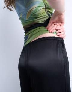 Model wearing Satin tie waist wide leg trouser in black