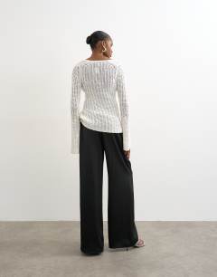 Model wearing Satin tie waist wide leg trouser in black