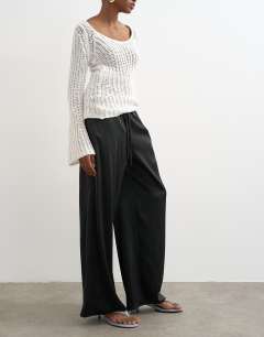 Model wearing Satin tie waist wide leg trouser in black