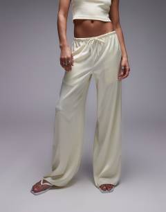 Model wearing Satin tie waist wide leg trouser in buttermilk
