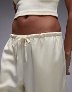Model wearing Satin tie waist wide leg trouser in buttermilk