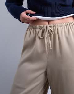 Model wearing Satin tie waist wide leg trouser in champagne