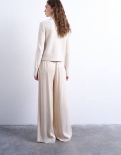 Model wearing Satin tie waist wide leg trouser in ecru