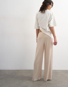 Model wearing Satin tie waist wide leg trouser in ecru