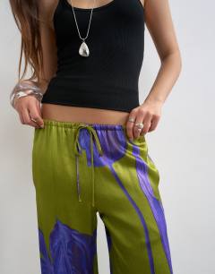 Model wearing Satin tie waist wide leg trouser in green and purple floral
