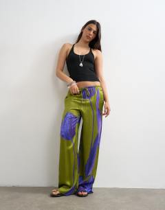 Model wearing Satin tie waist wide leg trouser in green and purple floral