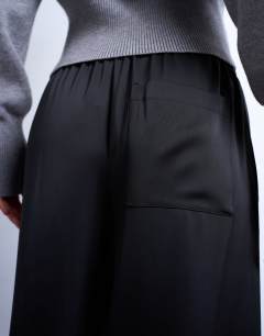 Model wearing Satin tie waist wide leg trouser with pintuck seam detail in black