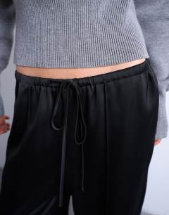 Model wearing Satin tie waist wide leg trouser with pintuck seam detail in black