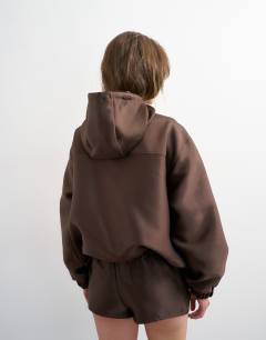 Model wearing Satin twill bomber co ord in brown