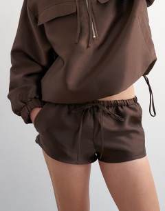 Model wearing Satin twill runner short co ord in brown