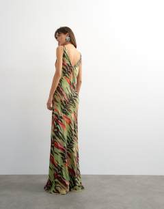 Model wearing Satin twist strap maxi dress in bright animal