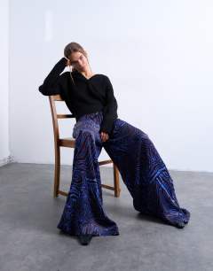 Model wearing Satin wide leg trouser in blue and burgundy print