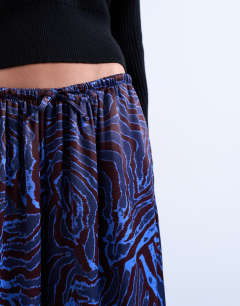 Model wearing Satin wide leg trouser in blue and burgundy print