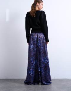 Model wearing Satin wide leg trouser in blue and burgundy print