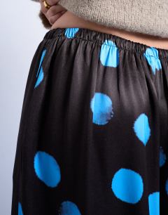 Model wearing Satin wide leg trousers in blue and brown polka dot
