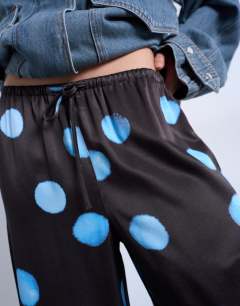 Model wearing Satin wide leg with tie waist trouser in polka dot