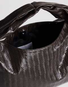 Model wearing Savan woven small shoulder bag in chocolate