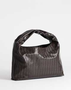 Model wearing Savan woven small shoulder bag in chocolate