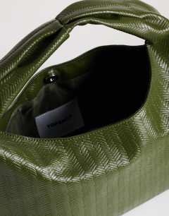 Model wearing Savan woven small shoulder bag in green