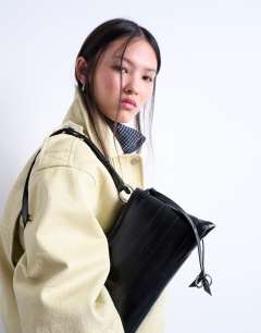 Model wearing Saxon textured shoulder bag in black