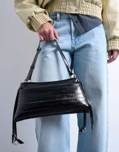 Model wearing Saxon textured shoulder bag in black