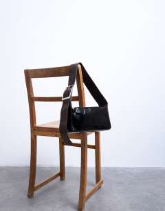 Model wearing Scarlett real leather suede shoulder bag with contrast strap in black and chocolate