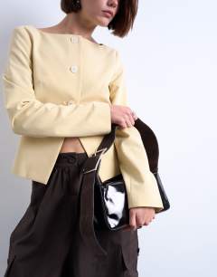 Model wearing Scarlett real leather suede shoulder bag with contrast strap in black and chocolate