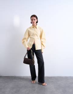 Model wearing Scarlett real leather suede shoulder bag with contrast strap in chocolate and snake