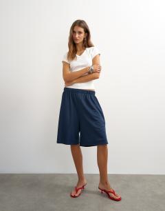 Model wearing Scoop v baby tee in white