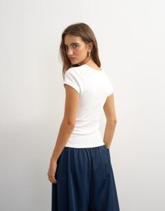 Model wearing Scoop v baby tee in white