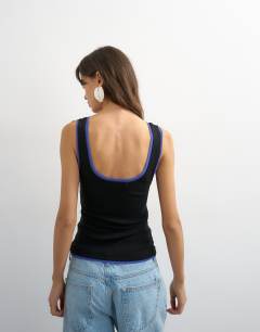 Model wearing Scoop vest with contrast mesh tipping in black and blue
