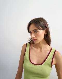 Model wearing Scoop vest with contrast mesh tipping in green & plum