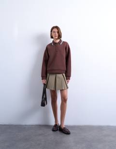 Model wearing Scuba-style fabric knit collar piped polo sweat in chocolate brown