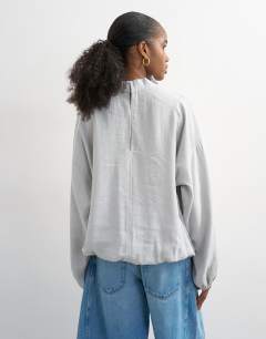 Model wearing Seam detail cuffed long sleeve top in grey